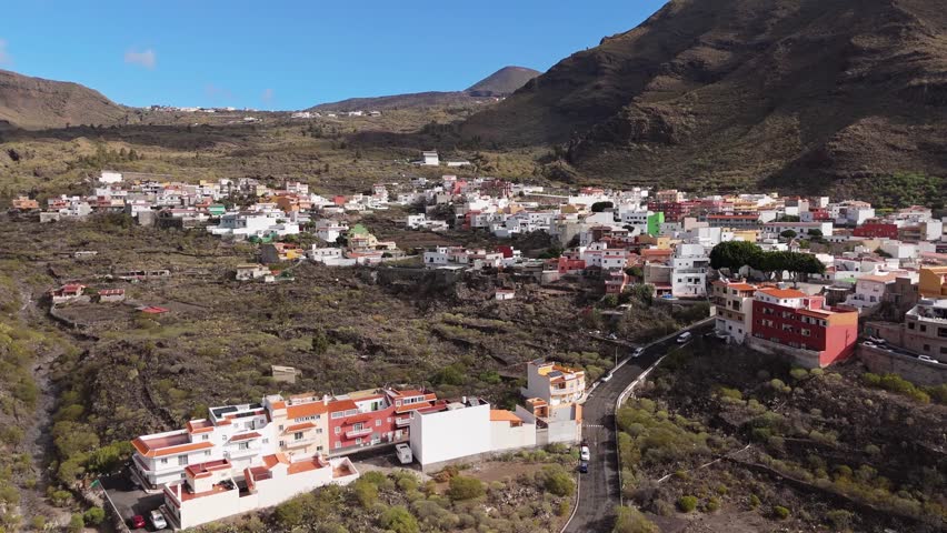 Aerial Landscape of Los Gigantes area explored by Drone POV in Tenerife. Los Gigantes is a famous giant rock formation with a nearby resort town. Ambient drone exploration of Spanish island. 