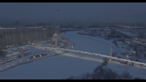 Drone Flying above Illuminated Pavshinskiy Bridge Snowy