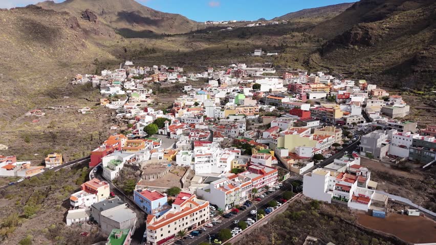 Aerial Landscape of Los Gigantes area explored by Drone POV in Tenerife. Los Gigantes is a famous giant rock formation with a nearby resort town. Ambient drone exploration of Spanish island. 