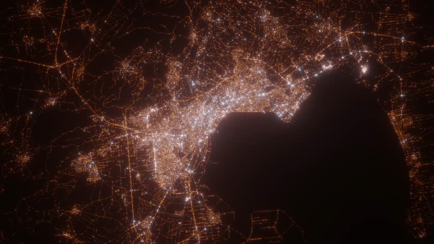 Thessaloniki (Greece) aerial view at night. Top view on modern city with street lights. Camera is zooming out, rotating counterclockwise. Vertical video. The north is on the left side