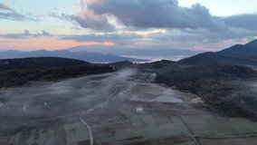 Aerial footage of a mountain misty valley with a view of colourful dawn light over the distant sea. - Powered by Shutterstock - Get 15% off with code: PIKWIZARD15