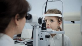 Optometrist examining child eyes with slit lamp - Powered by Shutterstock - Get 15% off with code: PIKWIZARD15