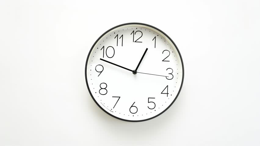 Classic white wall clock with black frame showing time passing, perfect for time management and business concepts