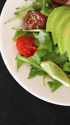 Avocado salad egg, tomato, onion, green leaf salad vegetable dish natural tasty snack fresh gourmet food background on the table rustic top view copy space keto and paleo diet vegan and vegan food