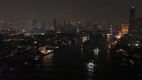Aerial view of illuminated skyscrapers in Bangkok city and Chao Phraya River in night time, 4k - Powered by Shutterstock - Get 15% off with code: PIKWIZARD15