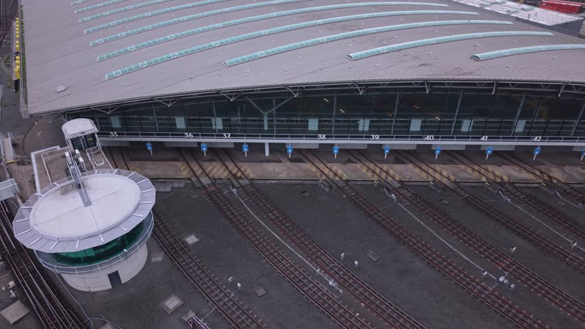 Rail Yard Aerial View Shows Tracks and Maintenance Facility at Sunset in Urban Area