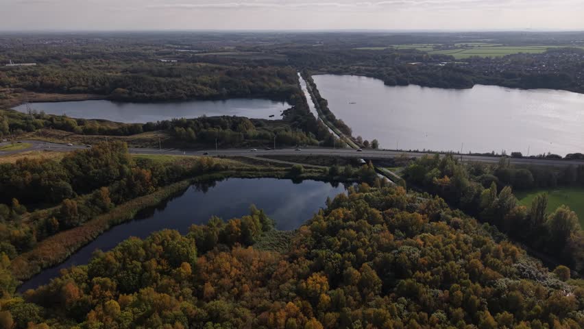 Scenic aerial view of multiple lakes and vibrant autumn foliage in a tranquil landscape