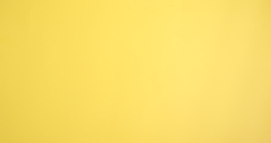 Woman with scroll of old parchment paper on yellow background, closeup