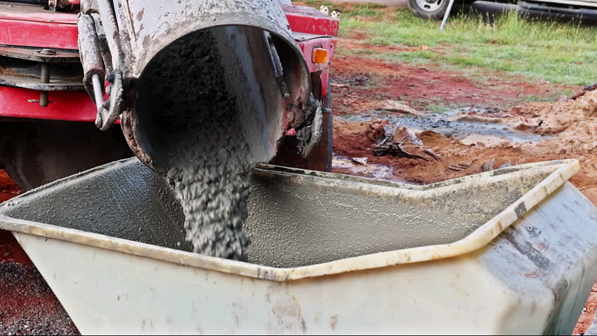 Construction site concrete buggy with wheelbarrow track wet concrete in cement truck chute