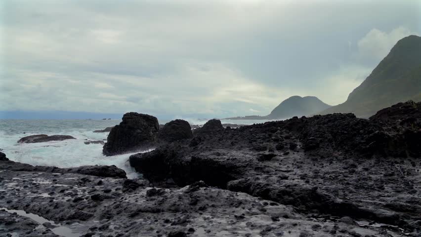 Hualian Shimen Sea Erosion Cave, Shimen Cave (March Cave), Taiwan. Waves crash against the rocks