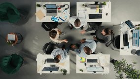 Top down view zoom in of staff proud of their successful teamwork collaboration, clapping hands after analysis. Employees use data visualization and forecasting for project objectives. Camera A. - Powered by Shutterstock - Get 15% off with code: PIKWIZARD15