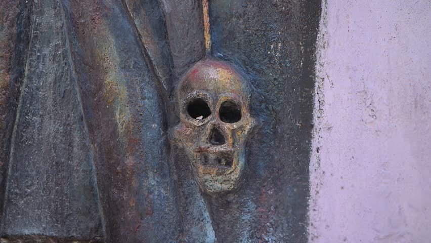 Port-au-Prince, Haiti - February 25 2019 -  human skull painted on a wall in a traditional Haitian cemetery 