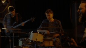 Camera cutting to close-up of singer with double-exposure hands drifting across guitar during music. Musicians, live performance, stage, rhythm, musical ensemble, nostalgic, artistic - Powered by Shutterstock - Get 15% off with code: PIKWIZARD15