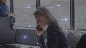 Seated coworker raising smartphone noting while pulsing overlay she tapping tablet collaborating. Collaboration, teamwork, connectivity, office, urban, modern, communication - Powered by Shutterstock - Get 15% off with code: PIKWIZARD15