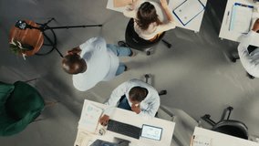 Top down view zoom out of diverse staff recording marketing ad for web advertisement in office, broadcasting live while coworkers solve their business tasks for productivity. Camera A. - Powered by Shutterstock - Get 15% off with code: PIKWIZARD15