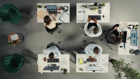 Top down view zoom in of diverse staff in office working on forecasting. Professional staff review visual data and diagrams to enhance effective management and business goals. Camera A. - Powered by Shutterstock - Get 15% off with code: PIKWIZARD15