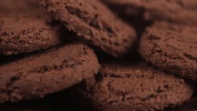 extreme close-up delicious fresh chocolate chip cookies stacked in pile. camera slowly pans over sweet homemade dessert, showcasing rich cocoa texture and details. - Powered by Shutterstock - Get 15% off with code: PIKWIZARD15