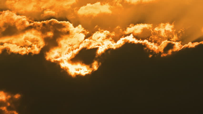 Peaceful morning sunrise time lapse with warm golden light and fast moving clouds.