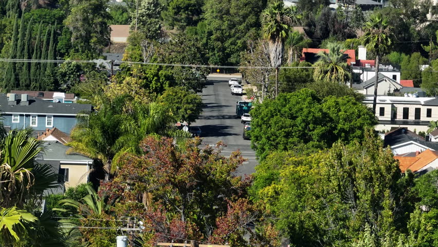 Telephoto drone shot of homes in the San Fernando valley, sunny day in Los Angeles