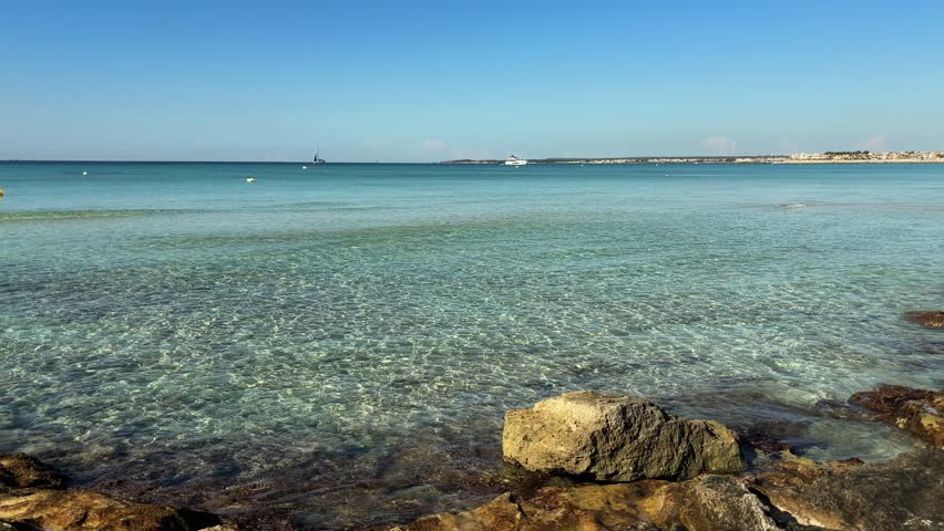 clear turquoise water and rocks at cala ses covetes beach mallorca spain