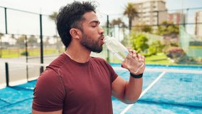 Man, fitness and drinking water with bottle in tennis court for hydration, recovery or rest. Active, person or sport player with mineral liquid, aqua or beverage for natural wellness or outdoor break - Powered by Shutterstock - Get 15% off with code: PIKWIZARD15
