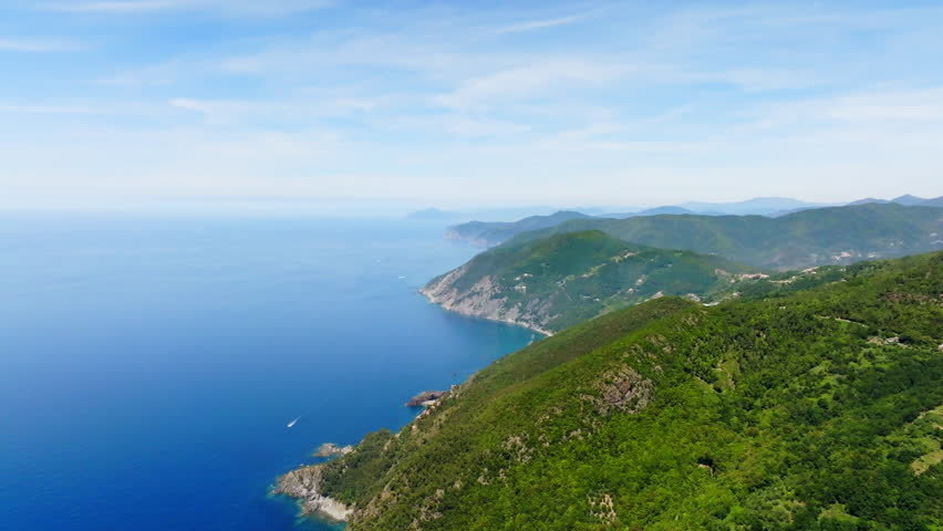 Aerial view overlooking the summer green mountainous coastline of Liguria, Italy