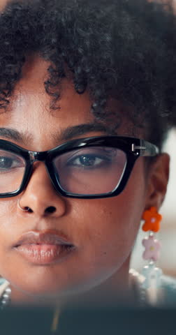 Creative, employee and woman with laptop, office and reading typography with glasses, online or app. Graphic designer, face and black person with blue light blocking eyewear and check for mistakes