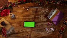 Top view of a Christmas gift wrapping scene with ribbons, scissors, paint, and homemade decorations on a rustic wooden table. Festive background for DIY holiday preparations with space for text. - Powered by Shutterstock - Get 15% off with code: PIKWIZARD15
