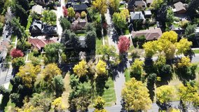 Denver aerial showing vacant land with wooded buffer, park-connected, bordered by upscale homes with tile roofing. Tree canopy in peak fall color adds depth to residential and ecological layout. USA - Powered by Shutterstock - Get 15% off with code: PIKWIZARD15