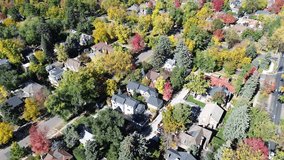 Washington Virginia Vale in Denver, CO showing curved streets lined with upscale homes and vibrant fall foliage in red, yellow, orange. Architectural styles vary across tile and shingle roofs. USA - Powered by Shutterstock - Get 15% off with code: PIKWIZARD15