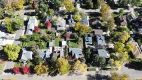 Mid-century homes in Washington Virginia Vale, Denver neighborhood featuring wide facades and deep lots. Dense fall foliage surrounds spacious backyards, suburban leisure and seasonal vibrancy. USA - Powered by Shutterstock - Get 15% off with code: PIKWIZARD15