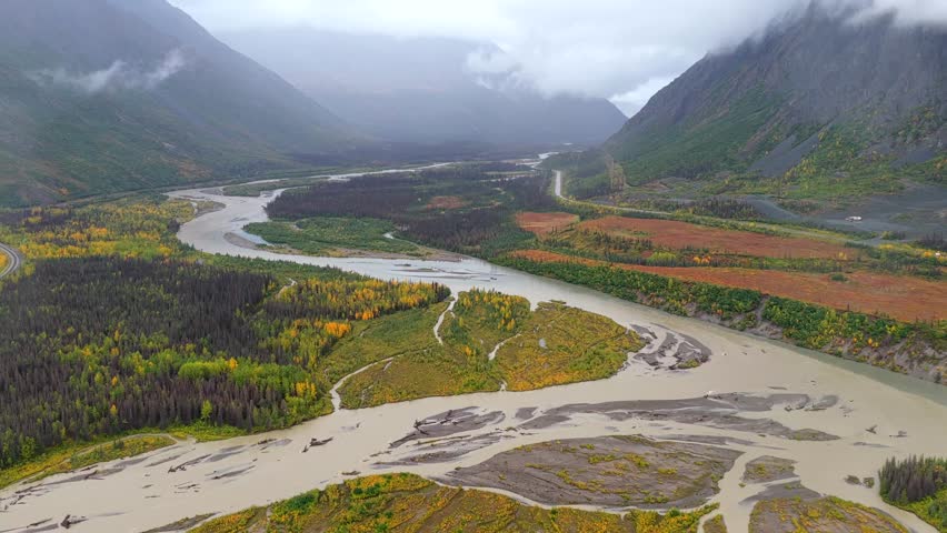 Aerial view of the Denali river valley showing the river flowing through the landscape with mountains in the background, Cantwell, Alaska, United States.