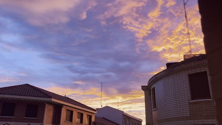 Red sunrise sky over city buildings in the early morning.