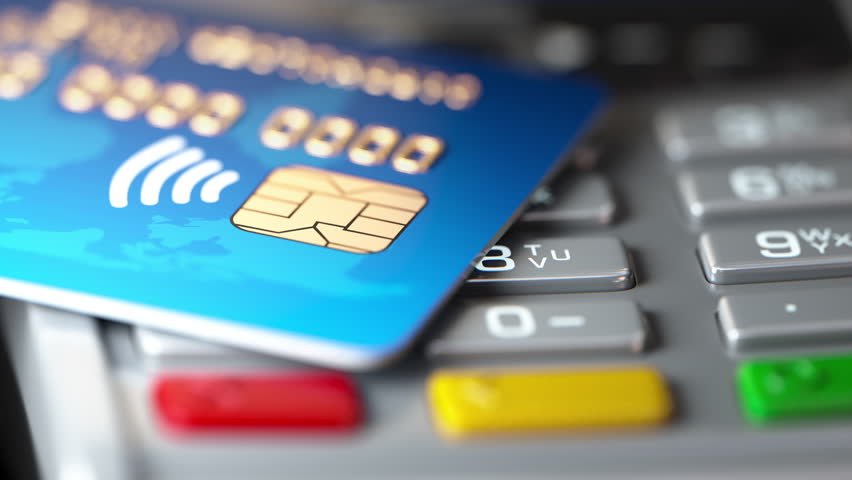 Credit card on POS terminal. Macro video animation with variable depth of field DOF effect.