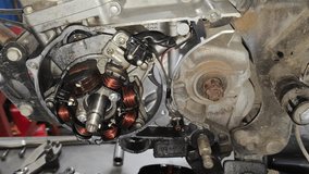 Mechanic Repairing 70cc Motorcycle Engine – Coil Side Maintenance Process Close-up - Powered by Shutterstock - Get 15% off with code: PIKWIZARD15