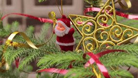 Christmas party or miracles and Santa Claus. Christmas tree with decoration. Close-up decorating Christmas tree with baubles balls on the background and santa claus small toy on tree and ball on tree. - Powered by Shutterstock - Get 15% off with code: PIKWIZARD15