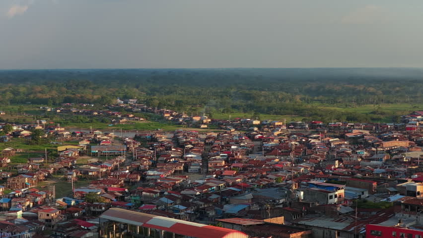 Aerial perspective of Iquitos, a vibrant city nestled in the heart of the vast and lush Amazon rainforest in Peru at sunset