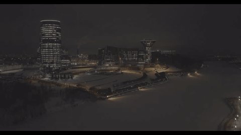 Drone Approaching Illuminated Modern Complex over Winter