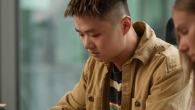 Informal business group three diverse multiracial workers working together at office Asian businessman task with computer Caucasian female writing notes African American woman chatting digital laptop - Powered by Shutterstock - Get 15% off with code: PIKWIZARD15