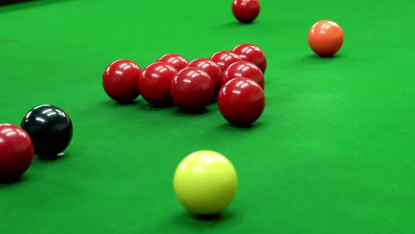 Snooker balls positioned on a green snooker table ready for a game to be played