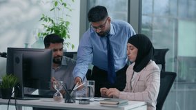 Three Muslim colleagues Arabian businessmen Indian businesswoman in hijab business team arguing discuss job task problem data in documents diagrams data financial result teamwork looking in computer - Powered by Shutterstock - Get 15% off with code: PIKWIZARD15