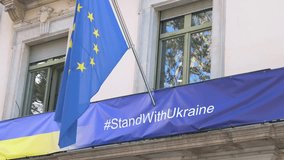 In Spain, a #StandWithUkraine banner is displayed with the EU and Ukrainian flags. The scene is a powerful symbol of European solidarity and political support for Ukraine during the ongoing conflict. - Powered by Shutterstock - Get 15% off with code: PIKWIZARD15