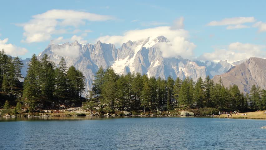 There are stories told in the cold of the mountains, in places where greatness confronts smallness and man feels infinite in the snow of the cold, snowy Alps and the lake is out of this world.