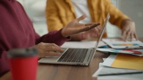 Two Arabian Indian businessmen informal casual business guys talking with African businesswoman Asian man laptop using technology online paperwork ethnic four colleagues communicate at company meeting - Powered by Shutterstock - Get 15% off with code: PIKWIZARD15
