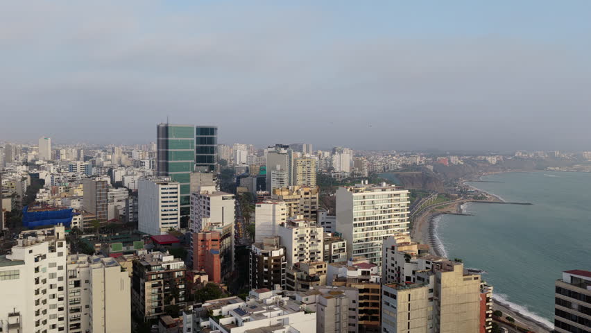 Aerial view of modern city of Lima, Peru. Majestic panorama of the Pacific Ocean coast and Miraflores district skyline