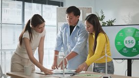 Professional Asian business team collaborating and brainstorming ideas for green ESG project in office meeting. Group of colleagues discussing sustainability, eco-friendly and corporate responsibility - Powered by Shutterstock - Get 15% off with code: PIKWIZARD15