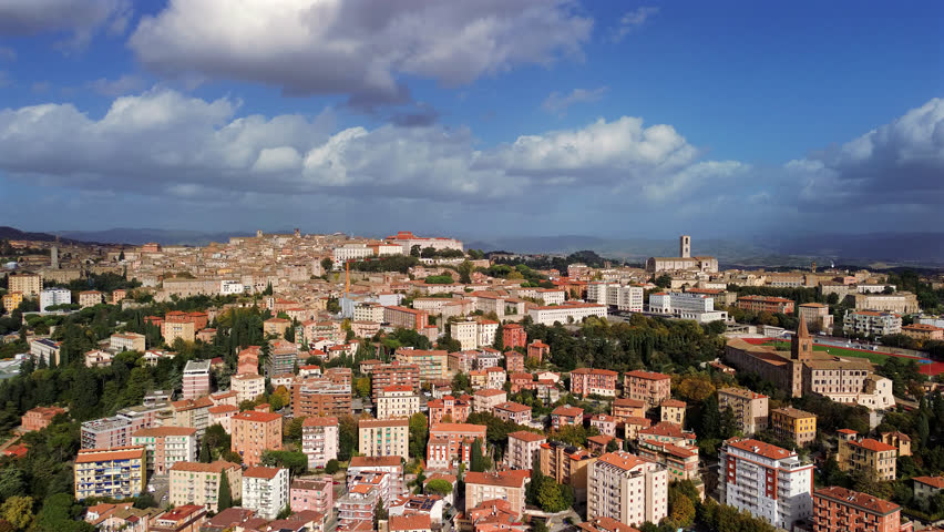 Drone Perugia city rooftops and cathedral with italian renaissance urban layout, pan