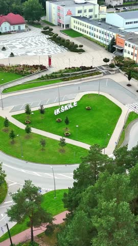 Aerial vertical drone shot of Ikšķile town sign in central park, Latvia