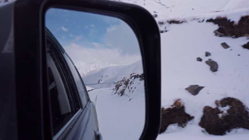 Rearview Mirror Snowy Mountain Road 