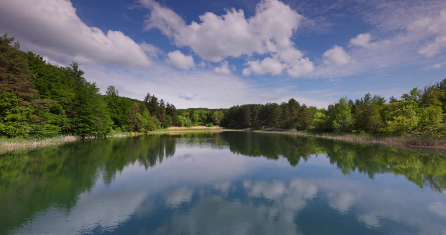 Serene Lake Landscape With Forest near the Shoreline Under Blue Sky in the Mountain Karandila, Bulgaria